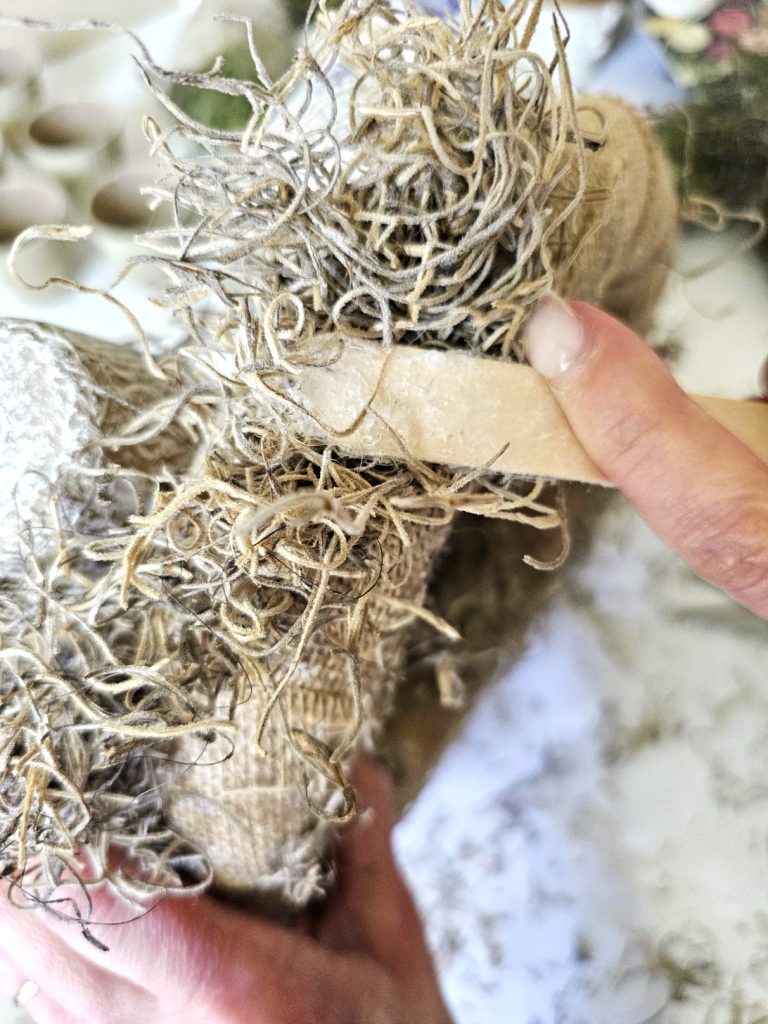 holding-spanish-moss-to-set-outer-part-of-wreath