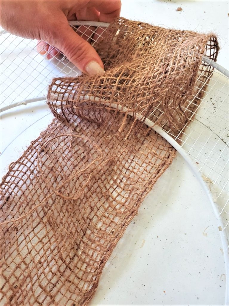 wreath-frame-adding-brown-burlap-to-cover-it
