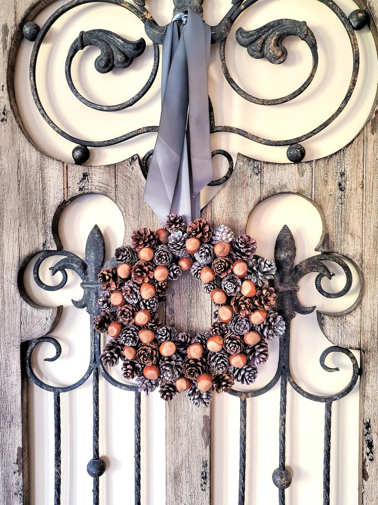 finished-wreath-hanging-on-gate-with-satin-ribbbon