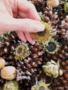 centerpiece-for-fall-with-nuts-dried-sunflower-heads