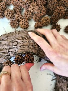 sweet-gum-ball-wreath-transform-your-decor-today-holding-pod-to-set