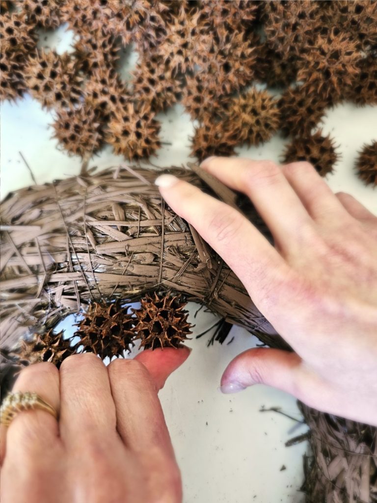 sweet-gum-ball-wreath-transform-your-decor-today-holding-pod-to-set