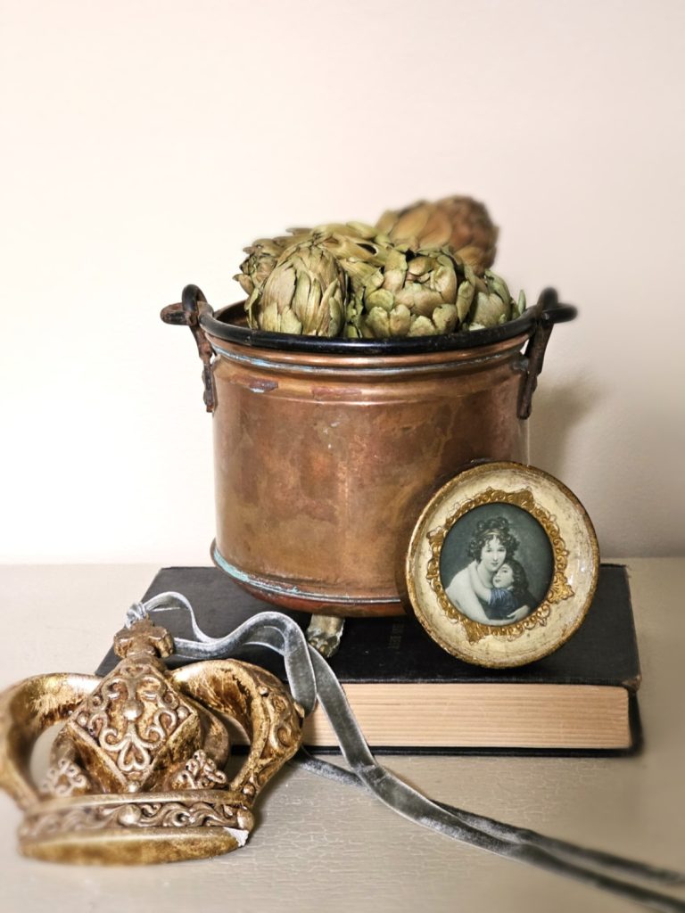 early-fall-decorating-ideas-for-a-cozy-home-now-dried-artichokes-copper-bowl-books-crown-florentine-picture