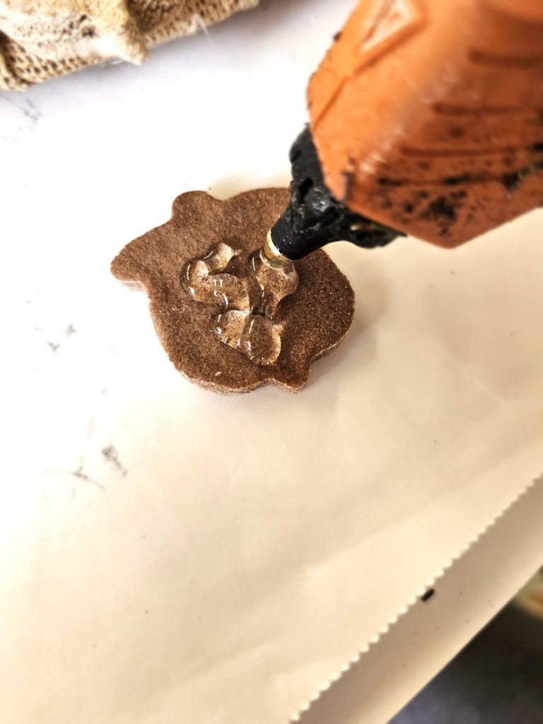 adding-glue-to-the-back-of-small-acorn