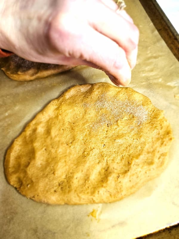 sprinkling-cinnamon-sugar-on-dough