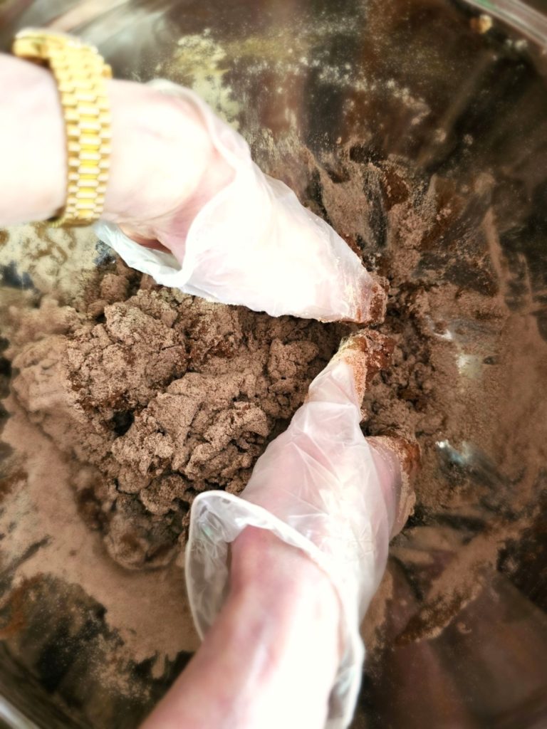 molded-cinnamon-salt-dough-ornaments-to-make-now-mixing-dough-with-gloves-to-combine-water-flours-and-spices