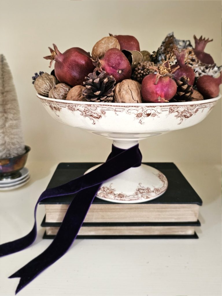 natural-christmas-decor-ideas-for-any-home-style-compote-with-pinecones-pomegrante-walnuts-crown