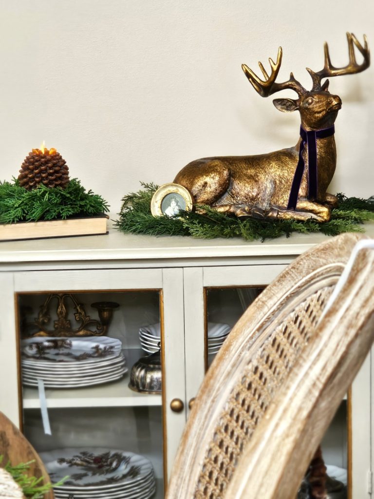 natural-christmas-decor-ideas-for-any-home-style-deer-on-greens-pinecone-flameless-candle