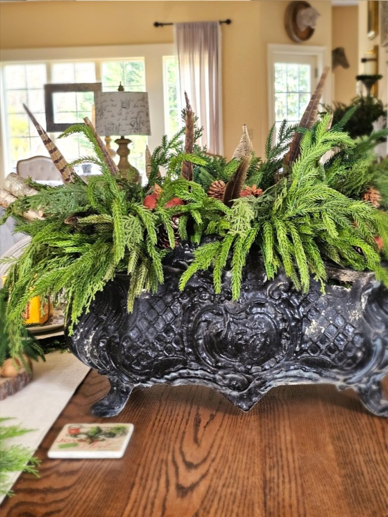 natural-christmas-decor-ideas-for-any-home-style-dining-room-table-greens-pheasant-feathers-pomegranate-pinecones