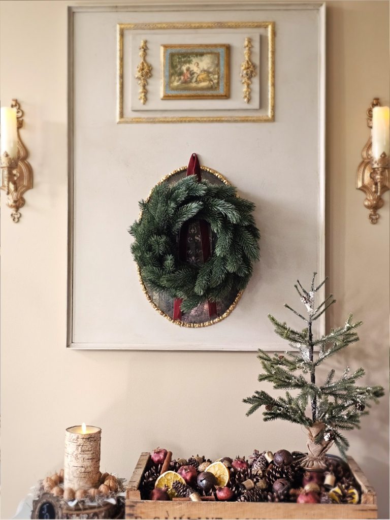 natural-christmas-decor-ideas-for-any-home-style-entry-table-mirror-wreath-seedling-wood-crate-flameless-candle