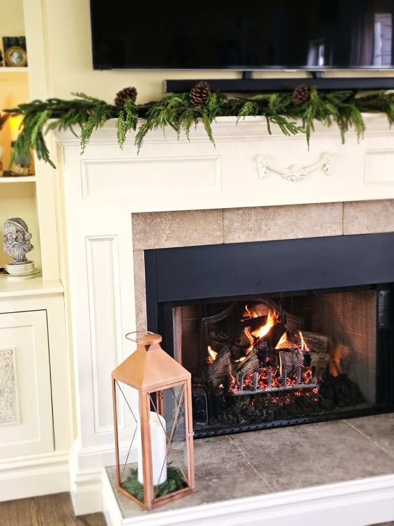 family-room-fireplace-with-greens-feathers-pinecones