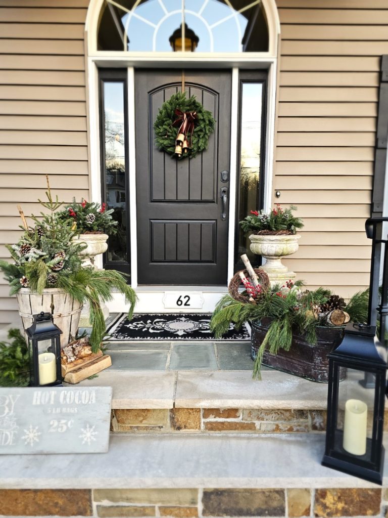 front-porch-with-greens-pinecones-birch-logs-lanterns