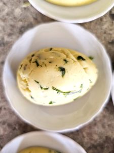 close-look-at-egg-shaped-butter-on-small-round-dish