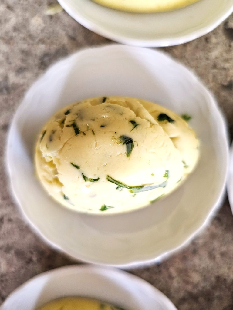 close-look-at-egg-shaped-butter-on-small-round-dish