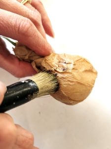 adding-brown-wax-to-paper-in-the-creases
