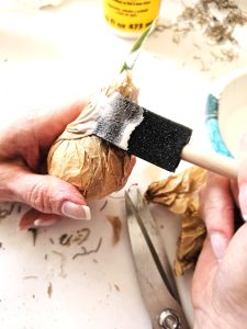 adding-glue-to-the-outside-top-of-the-bulb-paper