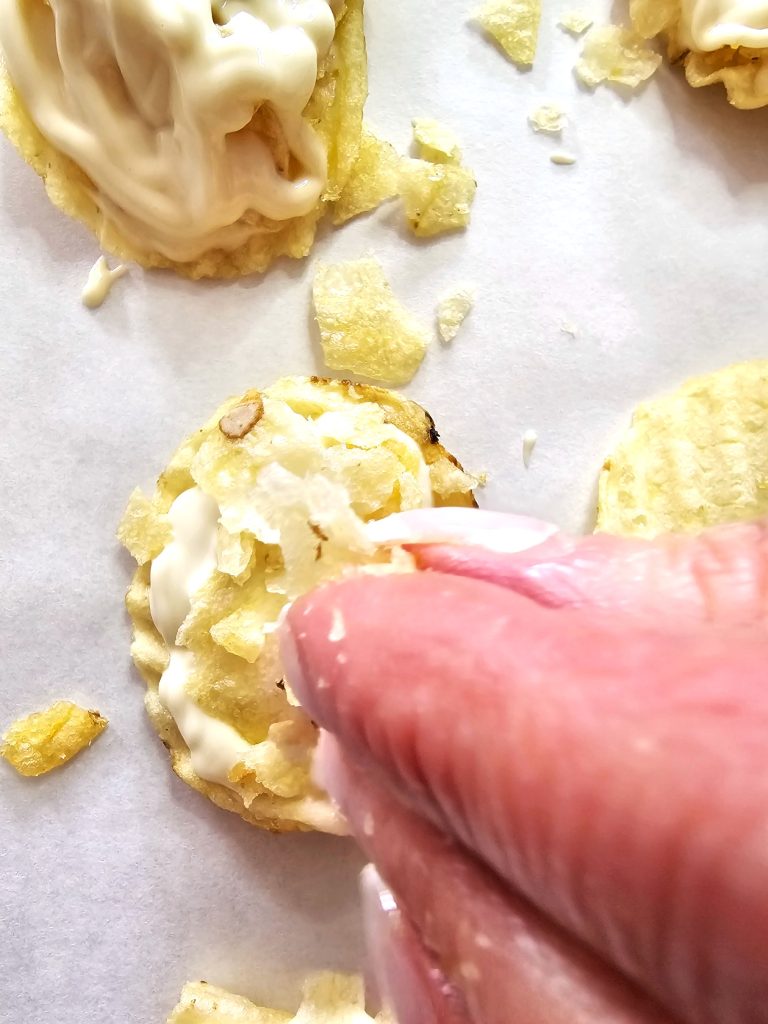 adding-broken-chips-on-top-of-drizzled-chocolate