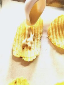 irresistible-chocolate-covered-chips-recipe-adding-chocolate-on-ruffle-chip-with-drizzle-tool