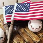 make-diy-vintage-spindle-american- flags-for-decor-two-flags-on-a-baseball-glove-and-baseballs