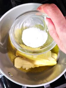 me-adding-salt-to-saucepan-for-the-sauce
