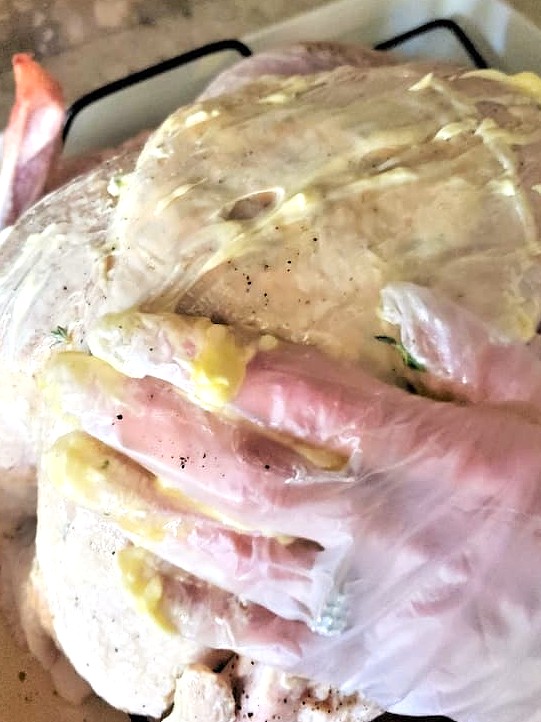 spreading-butter-oil-and oil-on-entire-turkey