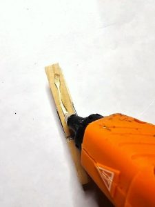 DIY-bottle-brush-star-tree-topper-easy-craft-idea-me-adding-glue-to-wood-clip