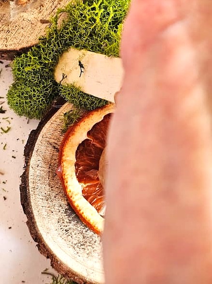 DIY-natural-wreath-with-organic-touches-me-holding-more-moss-to-set-with-stick