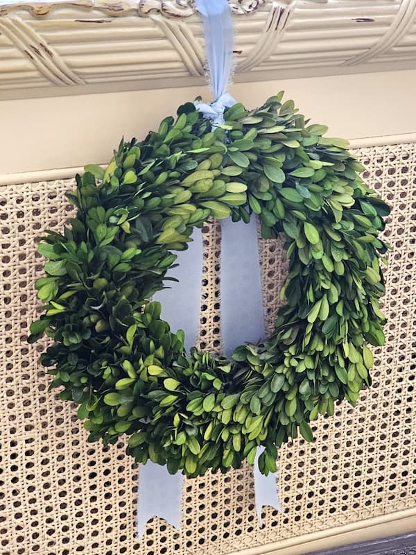 bowood-wreath-on-footboard-with-blue-ribbon