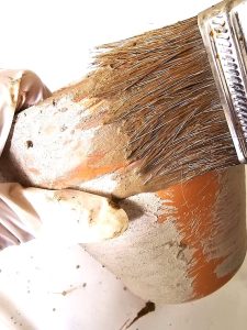 adding-lime-with-a-brush-to-a-big-pot